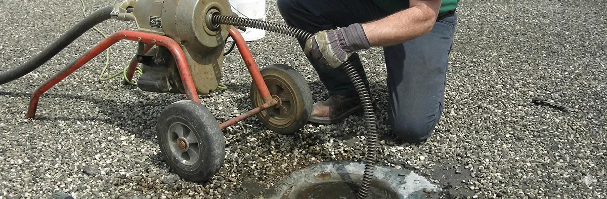 sewer rodding technician actively removing blockages from a sewer line in San Diego, CA