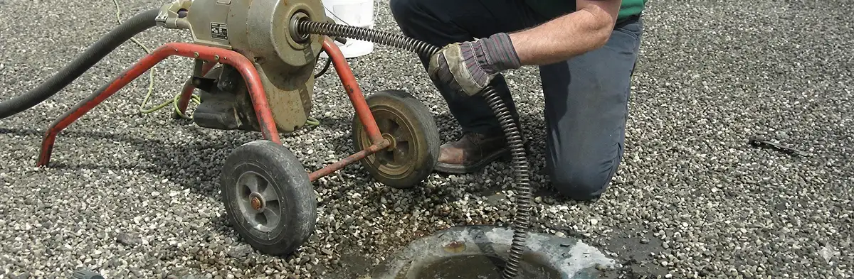 sewer rodding technician actively removing blockages from a sewer line in San Diego, CA